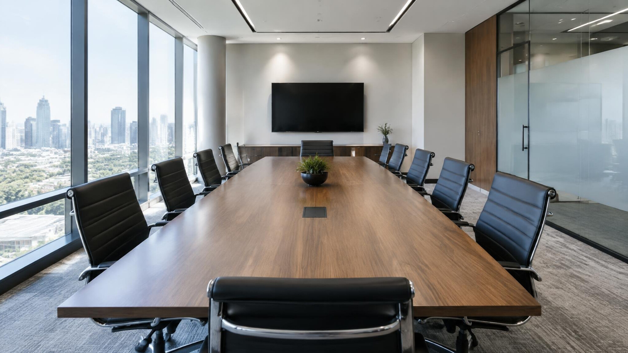 Empty modern conference room with large table and chairs